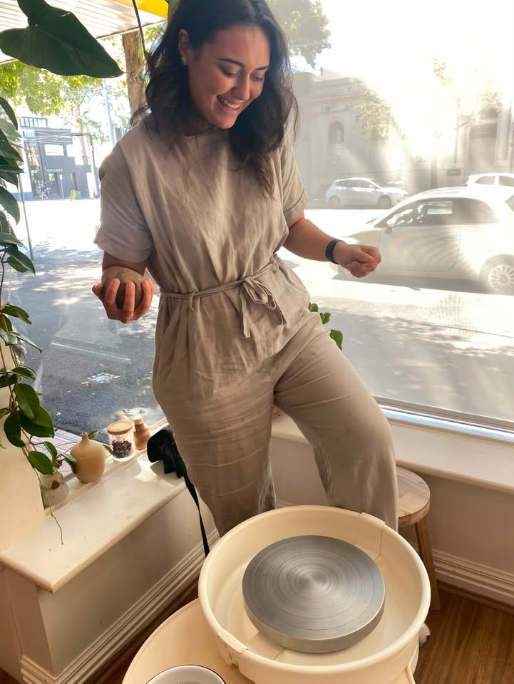 Louisa Harrison, ceramic artist, working at the pottery wheel in her studio